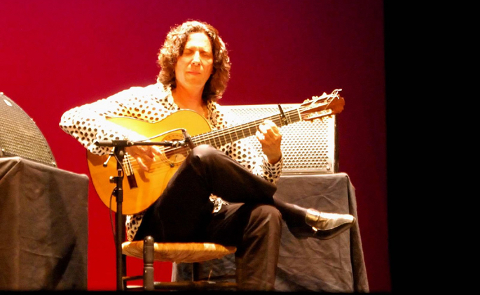 flamenco guitar player on stage performing