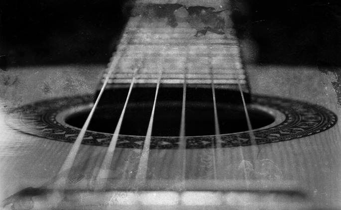 Extreme close up image of a flamenco guitar, looking from bridge to neck.