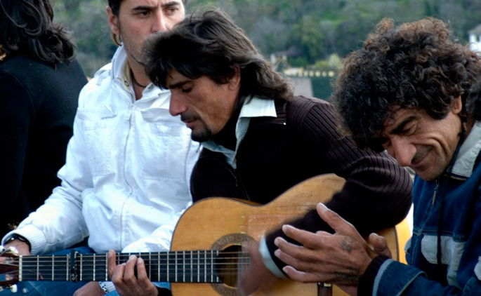 Flamenco guitarist and palmero performing informally outside